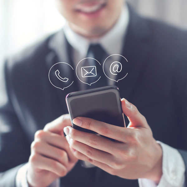 happy-businessman-holding-mobile-smartphone-with-mail-phone-email-icon